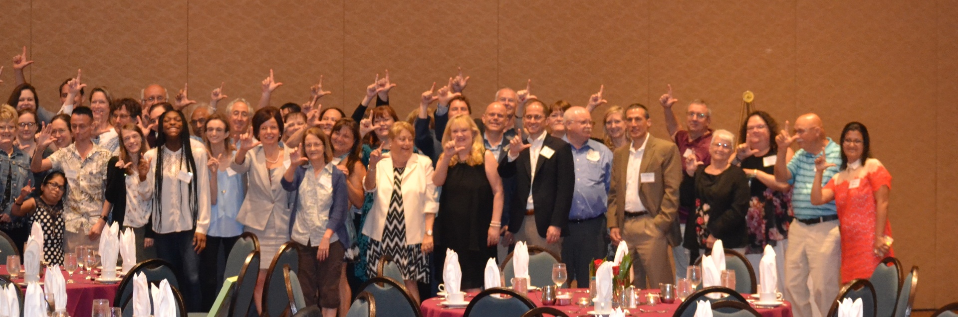 Community members forming the L sign
